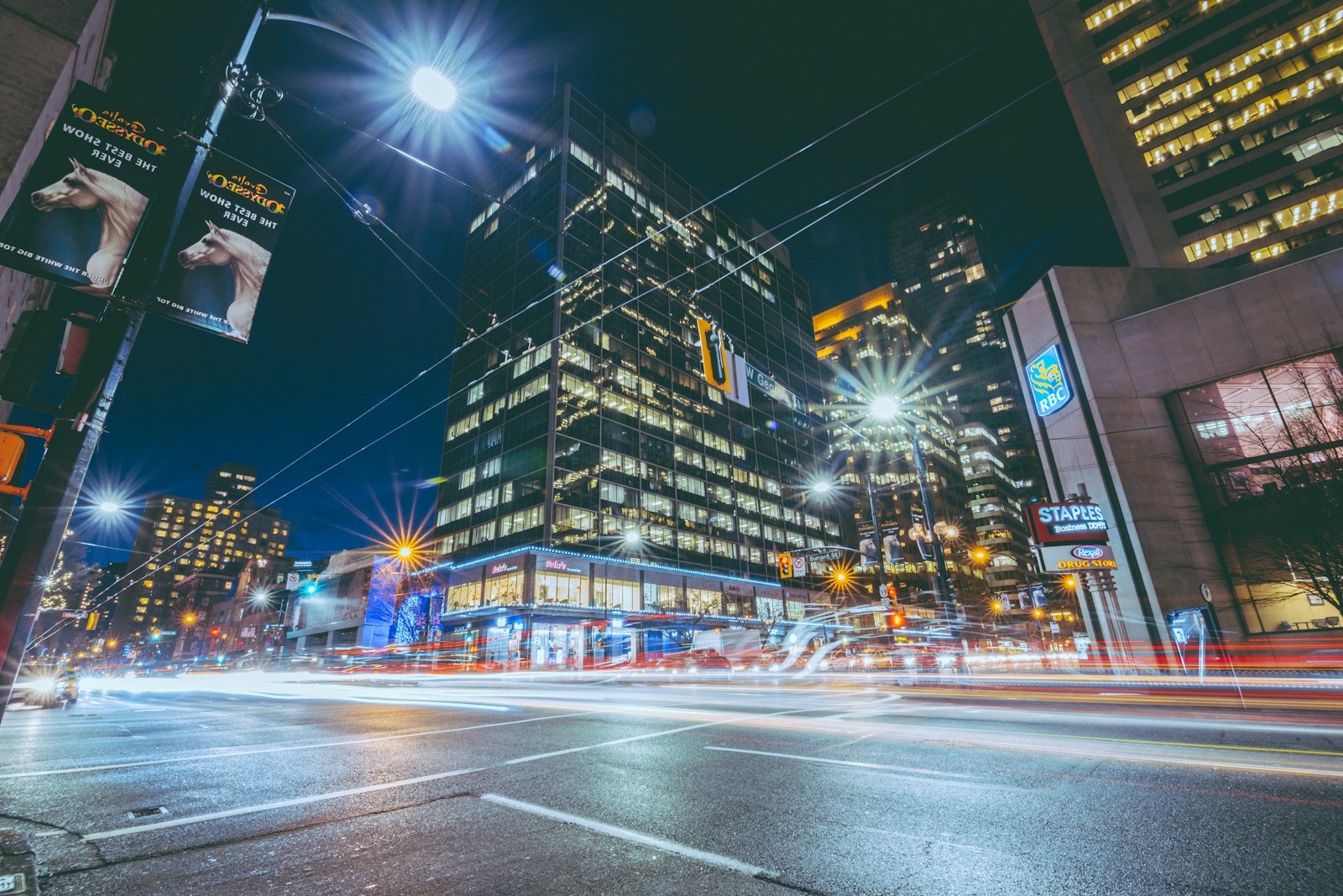 a city street at night with a lot of traffic